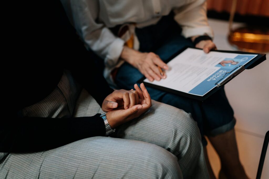 pexels photo 5989933 Two professionals reviewing a resume in an office setting, focused on teamwork.