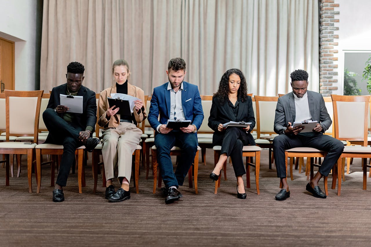 services-02 A diverse group of professionals attentively reviewing documents indoors.